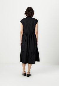 Black, midi-length dress with short sleeves, a fitted bodice, and a gathered waist. Features a tiered skirt and a smooth texture.