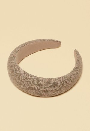 Wide padded headband with beige herringbone fabric texture, shown on a plain light beige background.