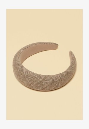Wide padded headband with beige herringbone fabric texture, shown on a plain light beige background.