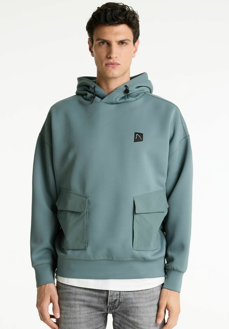 Türaus Polizeiaus hoodie aus weichem Material, mit einer Fronttasche, einer Kapuze mit Zugband und einem quadratischen Logo auf der Brust. Entworfen mit einem lockeren Schnitt.