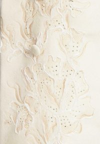Cream felt fabric features intricate floral embroidery in soft pink and white, embellished with golden sequins and a round fabric button.