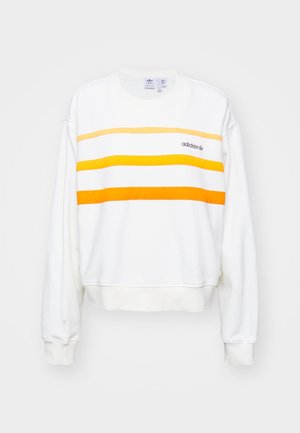 Witte Adidas sweater met drie horizontale strepen in tinten geel en oranje over de borst en logo aan de linkerkant.
