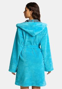 Turquoise hooded bathrobe in soft, plush material. Features long sleeves, a tie belt, and a grey lining inside the hood.