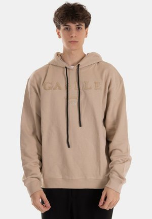 Felpa beige con cappuccio regolabile, grande stampa del logo sul davanti e polsini e orlo a costine. Realizzata in un morbido tessuto testurizzato.
