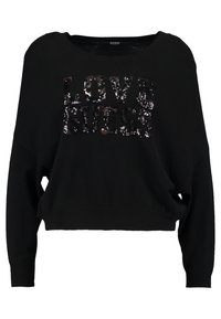 Schwarzer kurzer Pullover mit langen Ärmeln, weitem Ausschnitt und "LOVE GUESS" in glänzenden Pailletten auf der Vorderseite, aus weichem, strukturiertem Stoff.