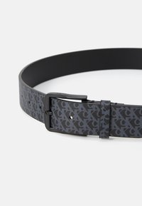 Black leather belt featuring a dark gray patterned design with subtle lettering, a black metal buckle, and five adjustment holes.