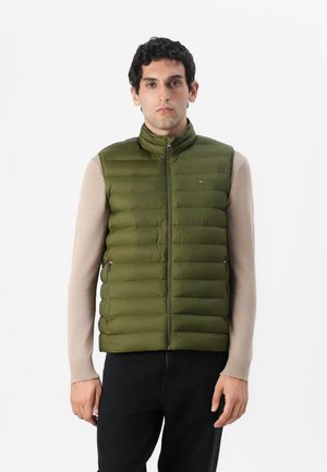 Olijfgroene gewatteerde vest met een hoge kraag, ritssluiting aan de voorkant en twee zijzakken. Kenmerkt zich door horizontale stiksels en een klein logo op de borst.
