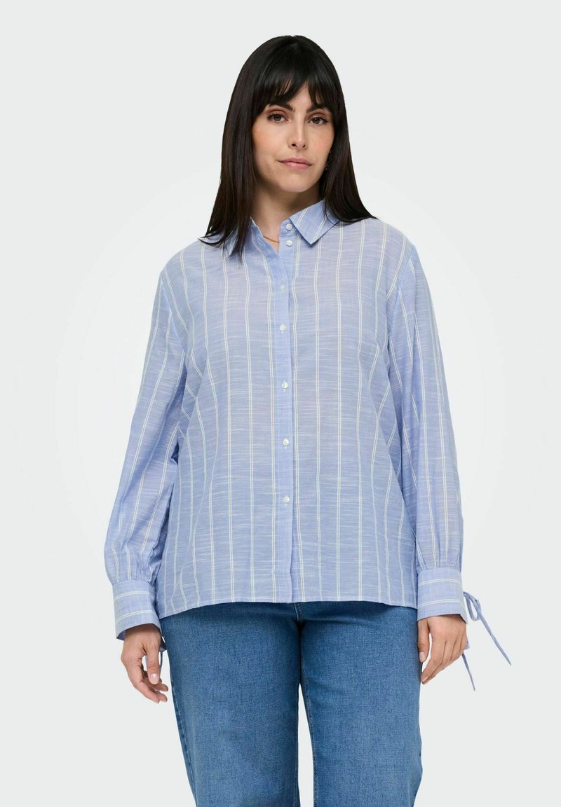 Light blue button-up shirt with subtle vertical stripes in white and pastel colors, long sleeves with tied cuffs, and a relaxed fit.