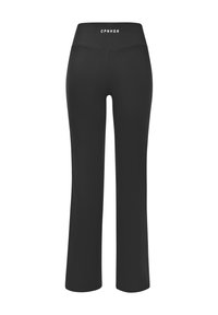 Black flared leggings made from stretchy material. Features a high waistband with white text "CPNHGN" at the back. Smooth texture.