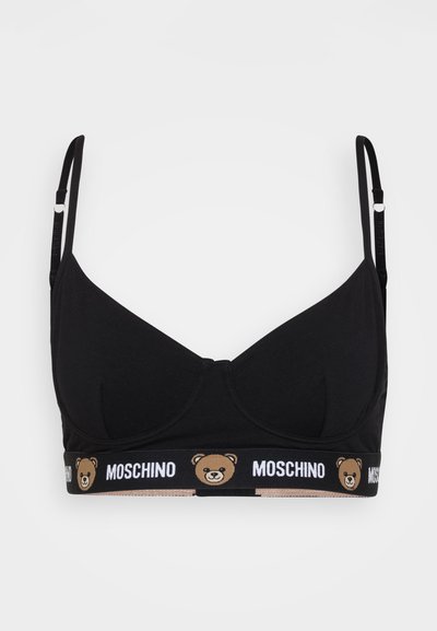 Sostenedor negro de algodón con copas moldeadas y tirantes ajustables. Presenta una banda elástica decorativa con "MOSCHINO" y un logo de oso en marrón.