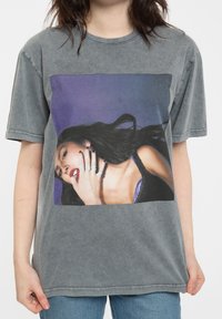 Gray, short-sleeve t-shirt with a large color image on the front. Features a soft texture and a crew neckline.