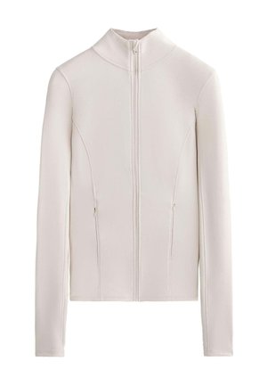 Giacca zip-up beige chiaro realizzata in tessuto liscio, con colletto alto, due tasche laterali e un design aderente con dettagli delle cuciture.