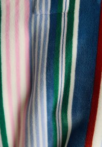 Striped fabric featuring vertical lines in pink, light blue, dark blue, green, and red. Soft texture with a velour finish.