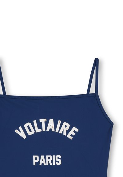 Camiseta sin mangas azul marino con tirantes finos, con letras blancas "VOLTAIRE" y "PARÍS" adornadas con pequeñas tachuelas decorativas.