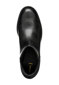 Botín negro de cuero con un acabado suave, puntera redondeada, paneles laterales elásticos y plantilla con marca. Diseñado para ser transpirable y cómodo.