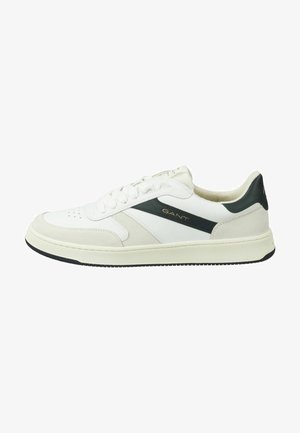 White leather sneakers with black accents and a textured gray panel. Features a round toe, lace-up closure, and rubber outsole.