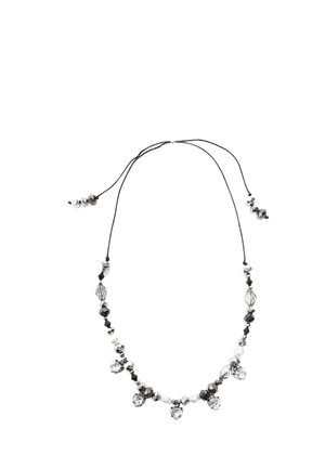 Necklace with black cord adorned with alternating black, white, and clear faceted beads and heart-shaped clear pendants.