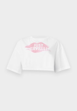 T-shirt blanc court à manches larges affichant une impression de lèvres roses et le texte "JUST CAVALLI" en blanc sur la poitrine.
