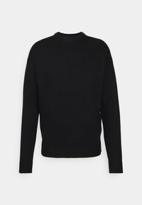 Pull noir avec un col rond côtelé, manches longues et une coupe décontractée. Fabriqué en maille texturée avec des détails côtelés à l'ourlet.