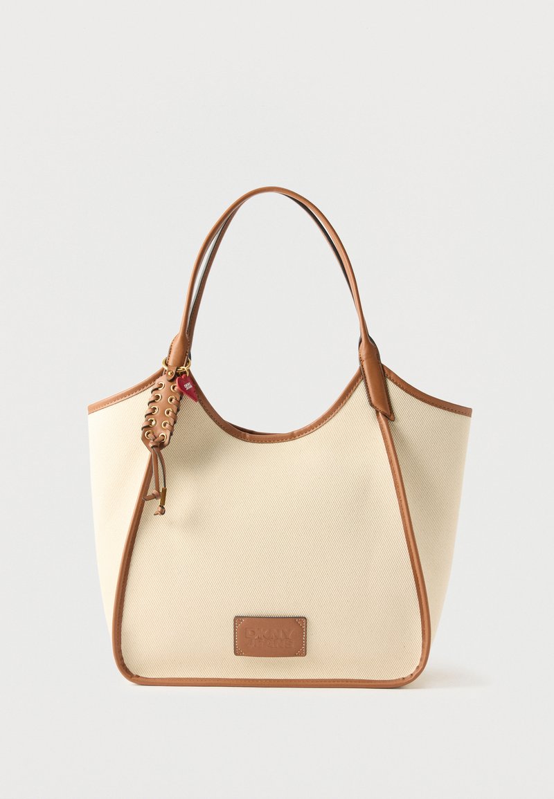 Καμβά τσάντα ώμου σε εκρού χρώμα με καφέ δερμάτινες λεπτομέρειες, δύο χερούλια, δέσιμο με κορδόνι και ένα μικρό κόκκινο καρδινάλιο σε μία πλευρά.