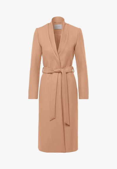 Beige wrap coat with long sleeves, a shawl collar, tie belt at the waist, and a textured fabric, suitable for layered styling.