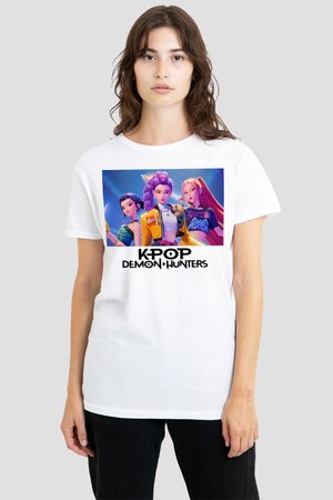 Young woman wearing white T-shirt with colorful animated design of three female characters and "KPOP DEMON HUNTERS" text below.