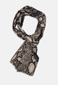 Foulard noir et beige à imprimé serpent, avec un tissu léger et texturé, des bords frangés et un design en boucle.