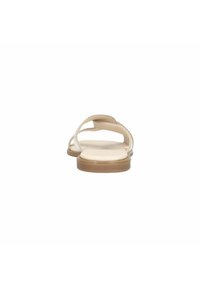 Beige sandals with two crossed straps, a flat sole, and a smooth texture. Minimalist design, showcasing a simple and clean aesthetic.
