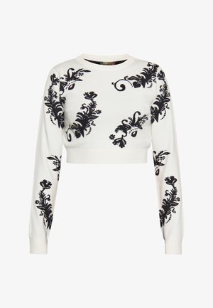 Fehér, rövidített pulóver, amelynek elülső részén és ujjain részletes fekete virágos hímzés található, kerek nyakkivágással és szűk mandzsettákkal.