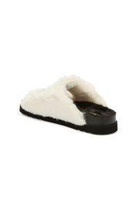 White faux fur slide sandal with an open toe, black rubber sole, and textured finish on the insole. Features a thick, fluffy exterior.