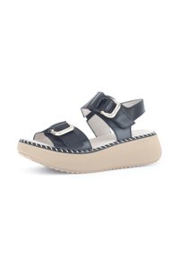 Black leather sandals with two adjustable straps, silver buckles, and a beige platform sole with textured tread and stitched detailing.