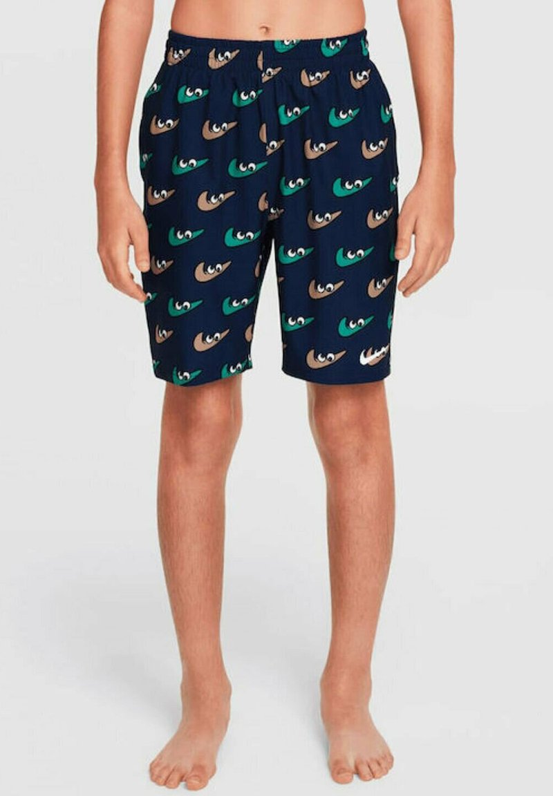 Bañadores para niños hechos de una tela ligera, con una base azul marino y un colorido patrón de ojos en tonos verdes, marrones y cremosos.