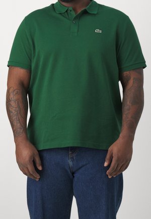 Green polo shirt in cotton with a classic collar and two-button placket. Features short sleeves and an embroidered logo on the chest.