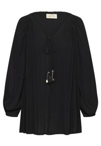Blouse noire à manches longues avec épaules froncées, col en V, fermeture à nouer avec pompons, et tissu légèrement texturé.