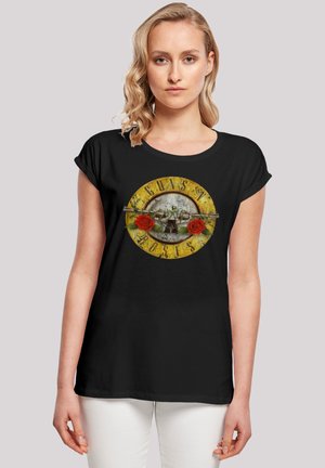 Black t-shirt featuring a circular graphic with a yellow and gray design, text "Guns N' Roses," and red roses on either side of a guitar.