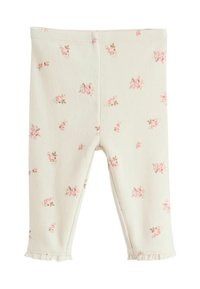 Krämfärgade leggings med mönster i rosa nyanser. Tillverkade av textil med struktur och har volanger vid anklarna.