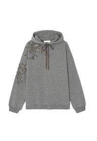 Sweat à capuche gris en tissu doux, avec des perles décoratives formant un motif floral sur un côté, doté d'une capuche avec cordon de serrage et d'une coupe oversize.