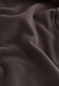 Dark brown soft fleece fabric with subtle folds and texture shown in close-up view.
