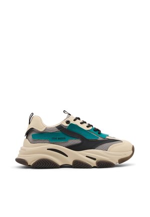 Chunky beige sneaker with black and teal accents, mesh details, and thick treaded sole, branded "Steve Madden" on side panel.