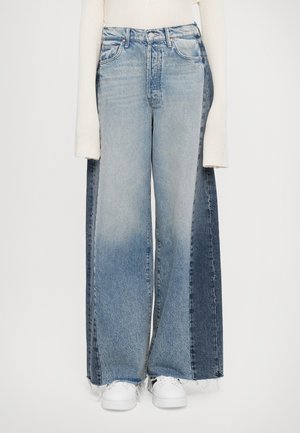 Wide-leg jeans featuring a two-tone design with light blue and dark blue denim. The fabric has a faded texture and frayed hems.