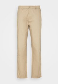 Beżowe chinosy o prostym kroju nogawek, wykonane z tkaniny płóciennej, z zapięciem na guzik i standardowymi kieszeniami. Gładka tekstura na całej powierzchni.