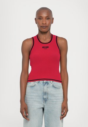 Rød ribbestrikket tanktopp med svart kant og "MOSCHINO JEANS" logo. Brukt med lyseblå denimjeans, som fremhever den tettsittende designen.