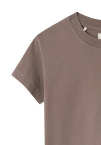 T-shirt a maniche corte con scollo tondo in un colore taupe tenue, realizzata in cotone morbido con texture liscia e dettagli di cuciture sottili.
