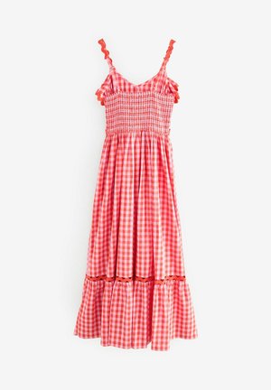 Rood-witte geruite jurk met gesmockte buste, ruches aan de schouderbanden en een gelaagde rok. Gemaakt van lichtgewicht stof met golvende accenten.