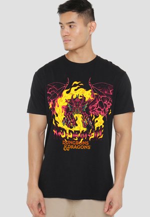 Black cotton t-shirt featuring a vibrant red and yellow dragon graphic with flames. Text reads "Dungeons & Dragons" in bold orange lettering.