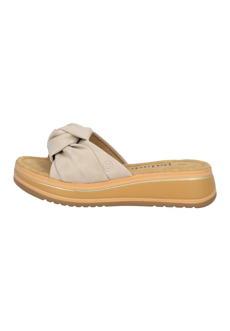 Beige Slippers mit Knopfdetail im Obermaterial, gepolstertem Fußbett und einer kontrastierenden, geschichteten Sohle, die eine Gummisohle für Traktion aufweist.