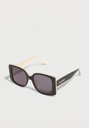 Schwarze, quadratische Sonnenbrille mit beigen Innenseiten der Bügel und dunklen Gläsern, mit "ALDO"-Markenaufdruck am Bügel.