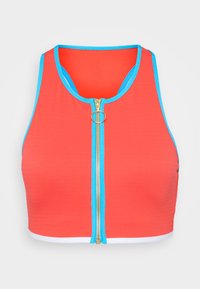 Red cropped tank top with a blue trimmed neckline, featuring a gold zipper with a circular pull tab and white hem at the bottom.