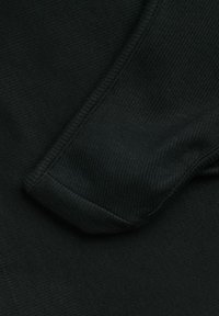 Tessuto a coste nero con una superficie liscia, caratterizzato da una manica piegata e dettagli di cucitura puliti. La forma complessiva è aderente.