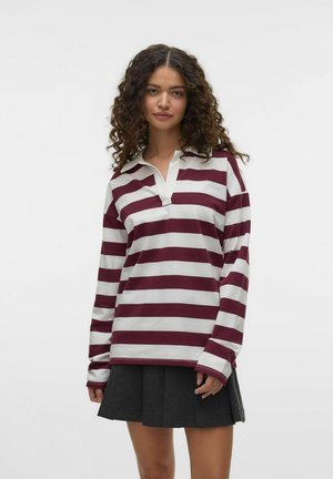 Maroon and white striped long-sleeve polo shirt with a collar and a notch at the neckline, paired with a dark pleated skirt.